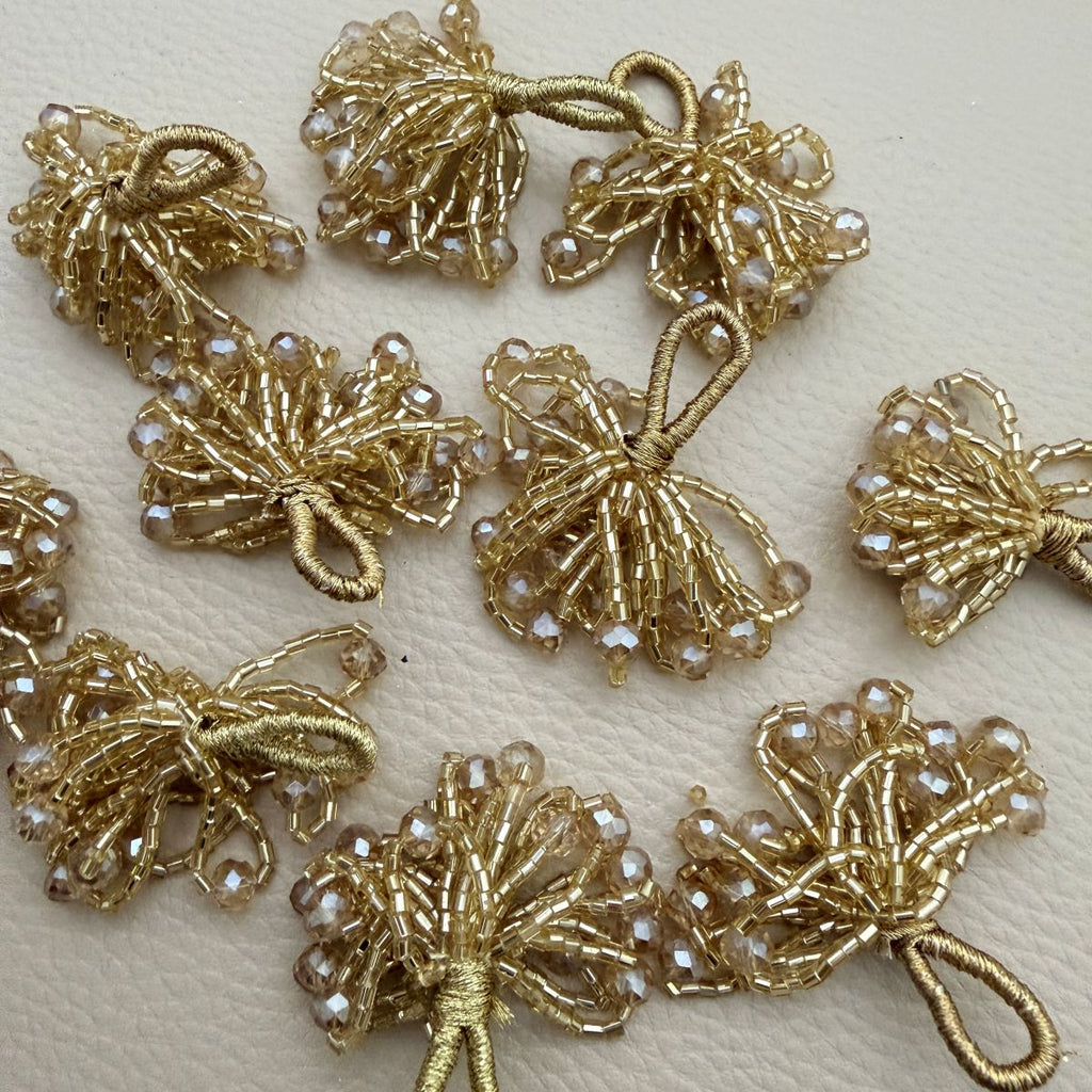 Set of 10 gold crystal bead bunch latkans arranged in two rows