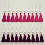 Plum tassels with pearl-style beads and gold-tone hanging cords