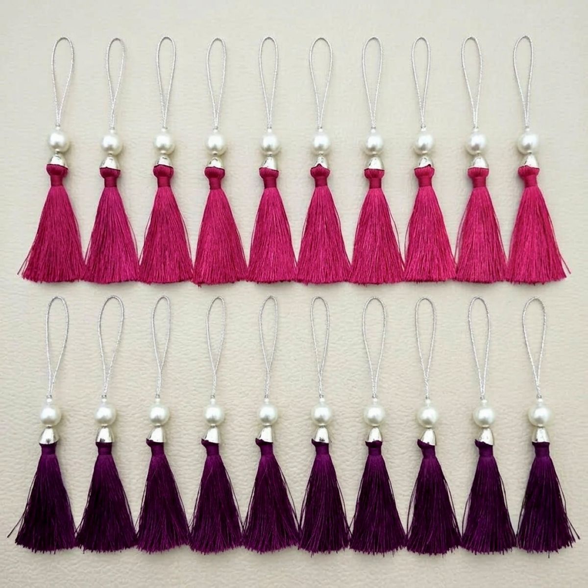 Plum tassels with pearl-style beads and gold-tone hanging cords