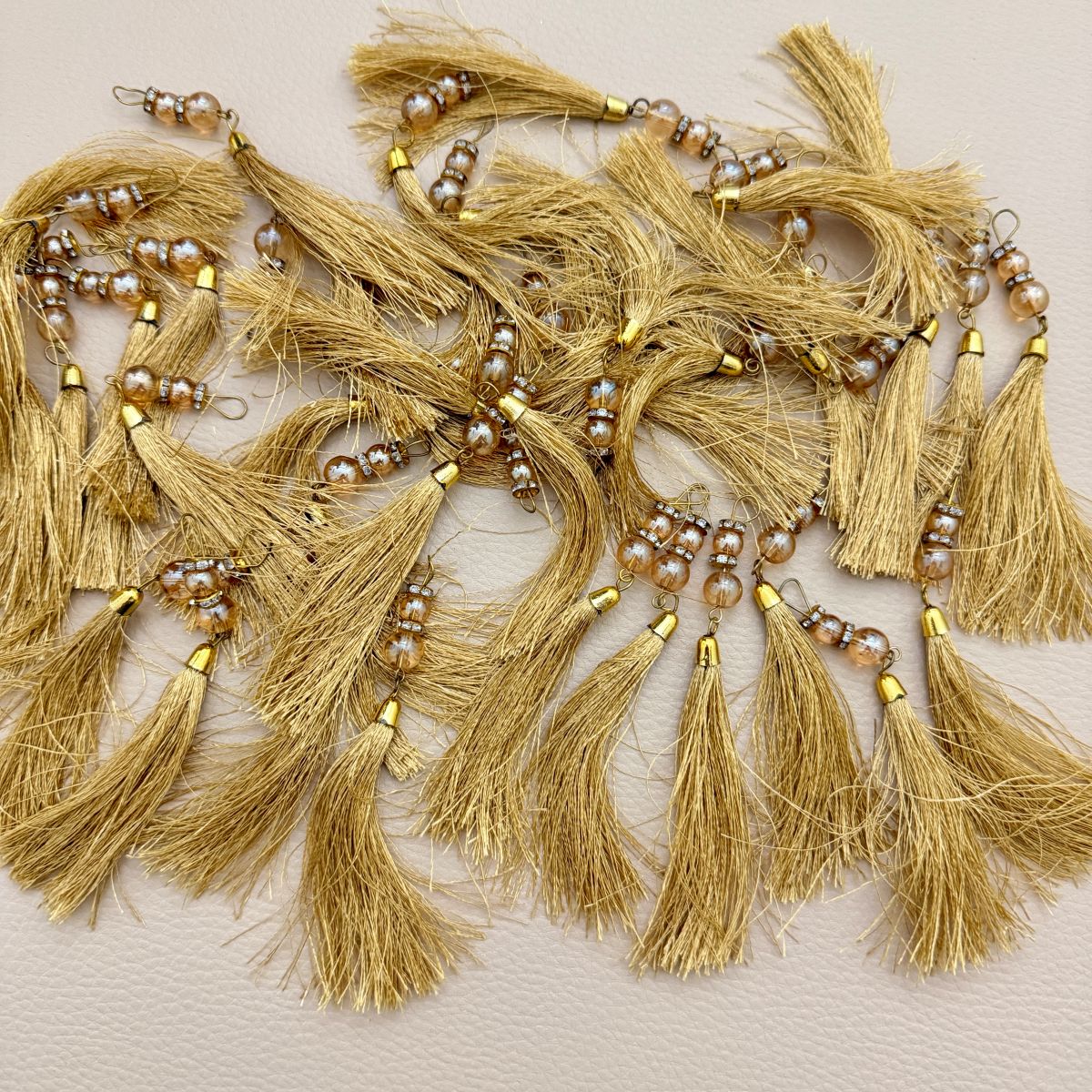 Single gold thread tassel with pearl-look beads, metallic spacers, and gold-tone cap