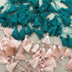 Teal green silk tassel latkan with pearl and crystal bead tips shown beside a ruler