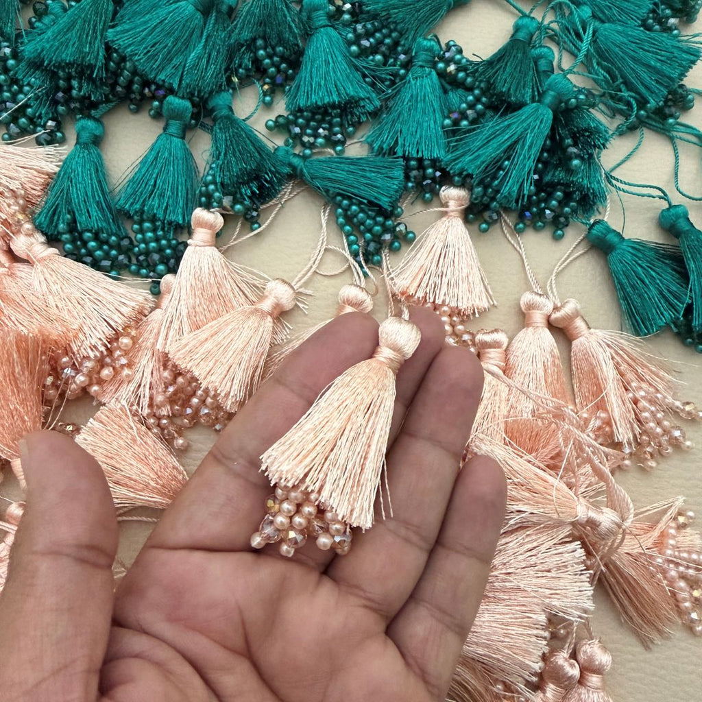 Close-up of teal green silk tassel with pearl and crystal bead cluster fringe