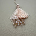 Teal green and blush peach silk tassel latkans grouped together