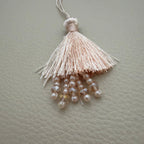 Teal green and blush peach silk tassel latkans grouped together