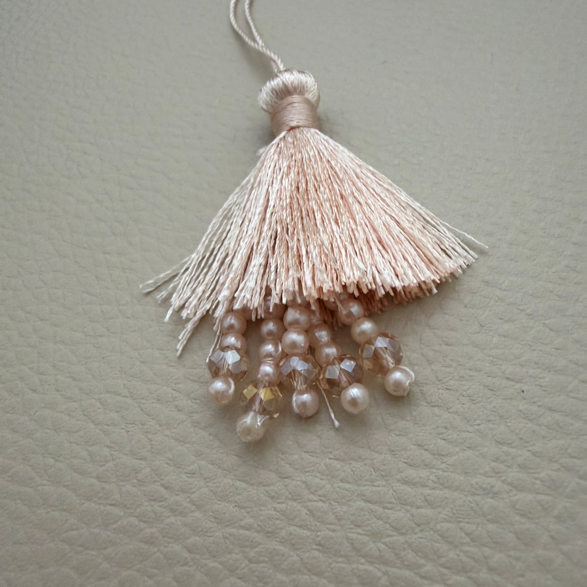Teal green and blush peach silk tassel latkans grouped together