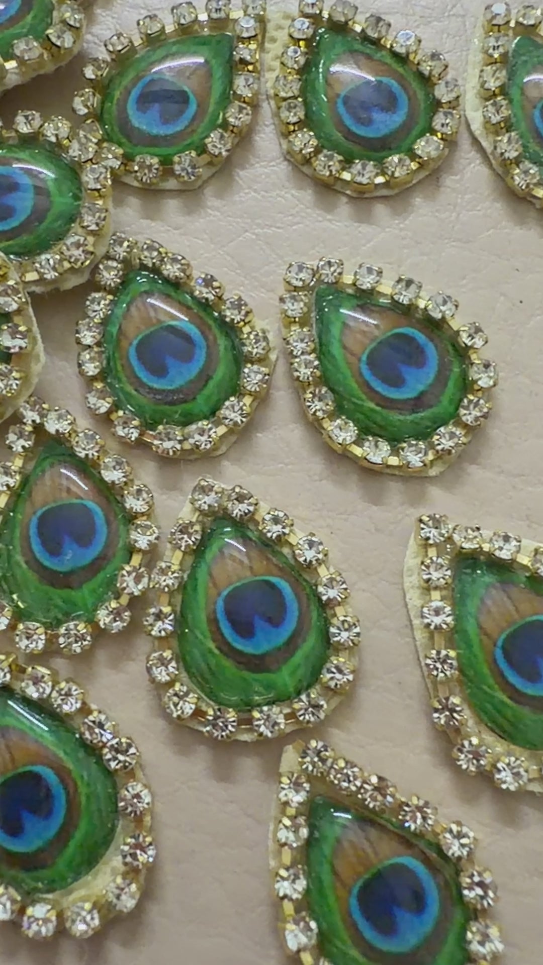 Decorative peacock feather patterns  blue centers on a beige background