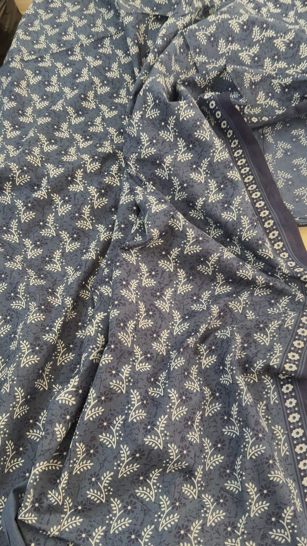 Navy blue scarf with white floral pattern on a white background