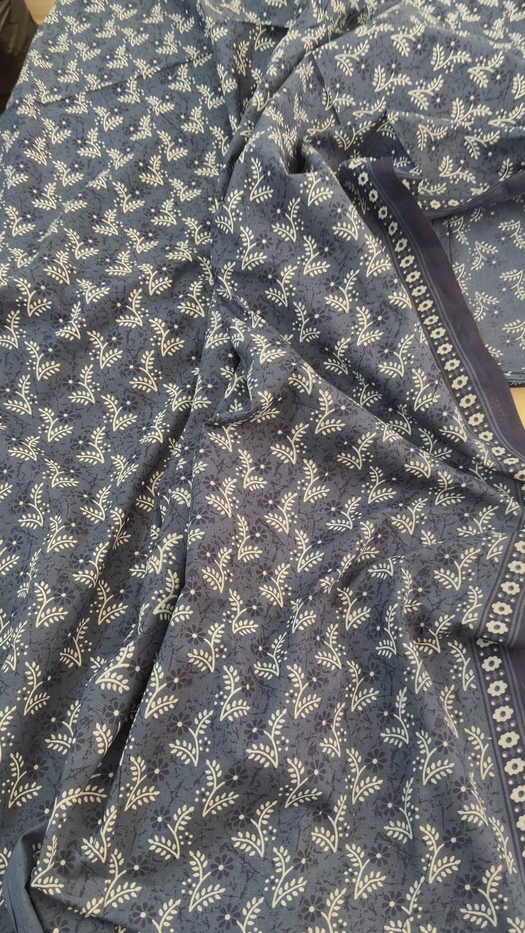 Navy blue scarf with white floral pattern on a white background