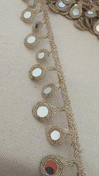 Decorative belt with mirror embellishments on a neutral background