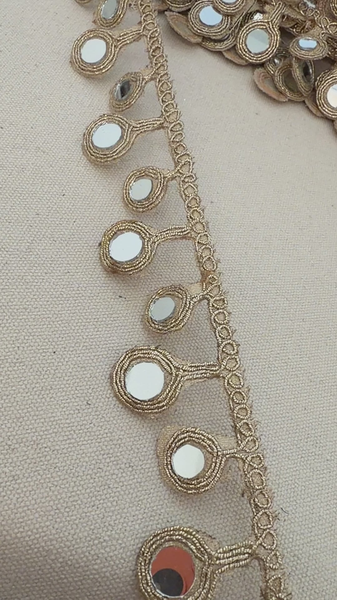 Decorative belt with mirror embellishments on a neutral background