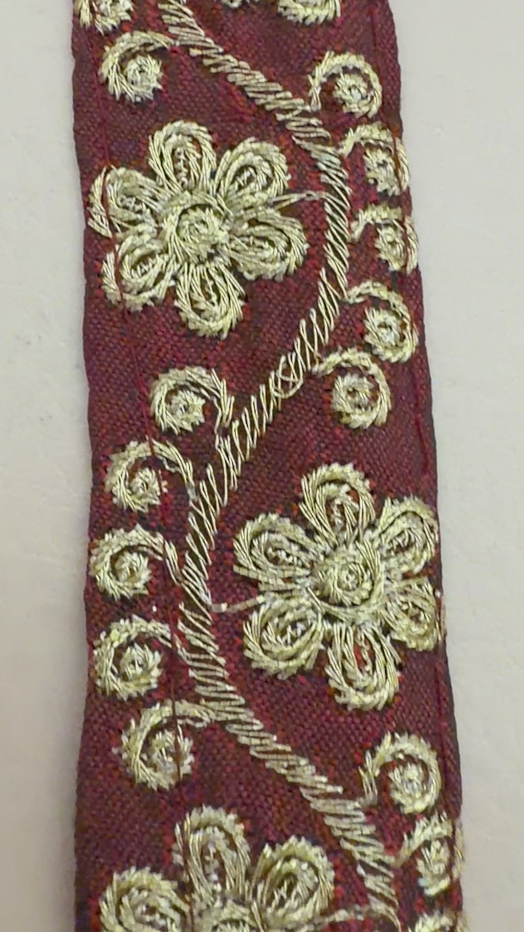 Decorative headband with floral embroidery on a white background
