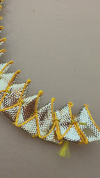 Close-up of gold and silver metallic lace on a beige background