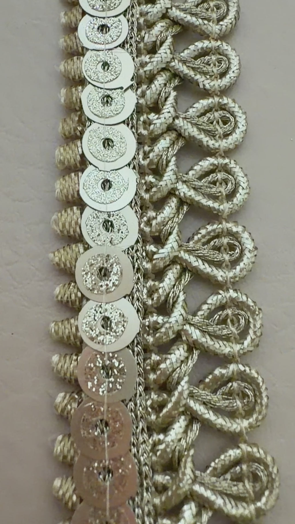 Decorative silver lace trim on a light background with a white flower.