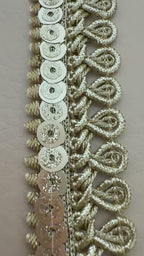 Decorative silver lace trim on a light background with a white flower.