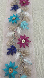 Decorative ribbon with floral embroidery on a light background