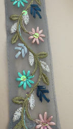 Embroidered beret with floral designs on a beige background