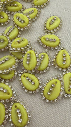 Green kiwi slices with decorative elements on a textured fabric background