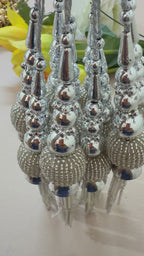 Pair of silver tassel earrings on a light background