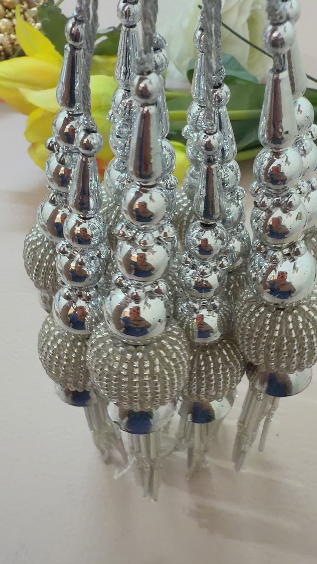 Pair of silver tassel earrings on a light background