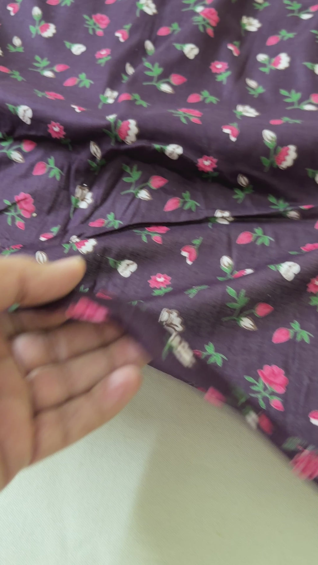 Folded Wine fabric with floral pattern on a white background