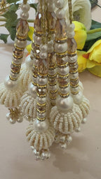 Beaded jewelry with pearls and gold accents on a light background