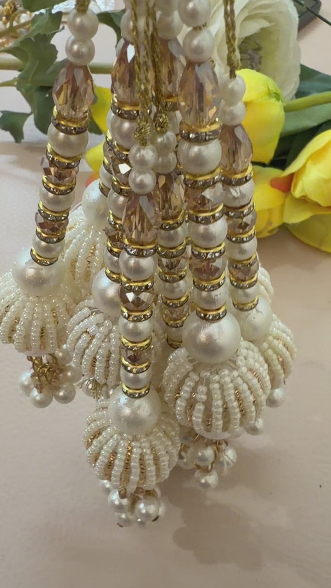 Beaded jewelry with pearls and gold accents on a light background
