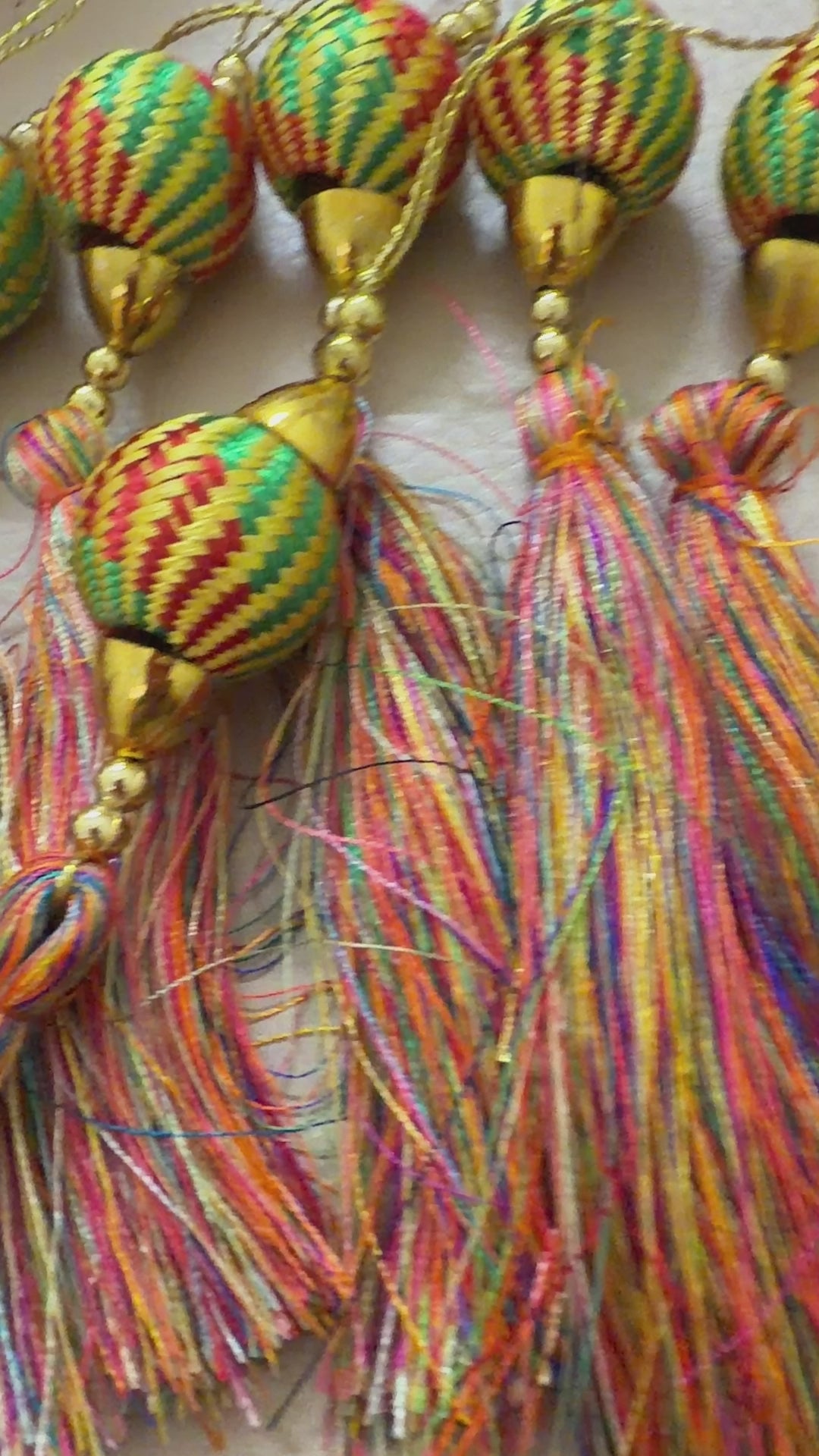 Set of tassel earrings with decorative beads on a light background