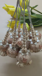 Decorative necklaces with floral and bead designs on a light background