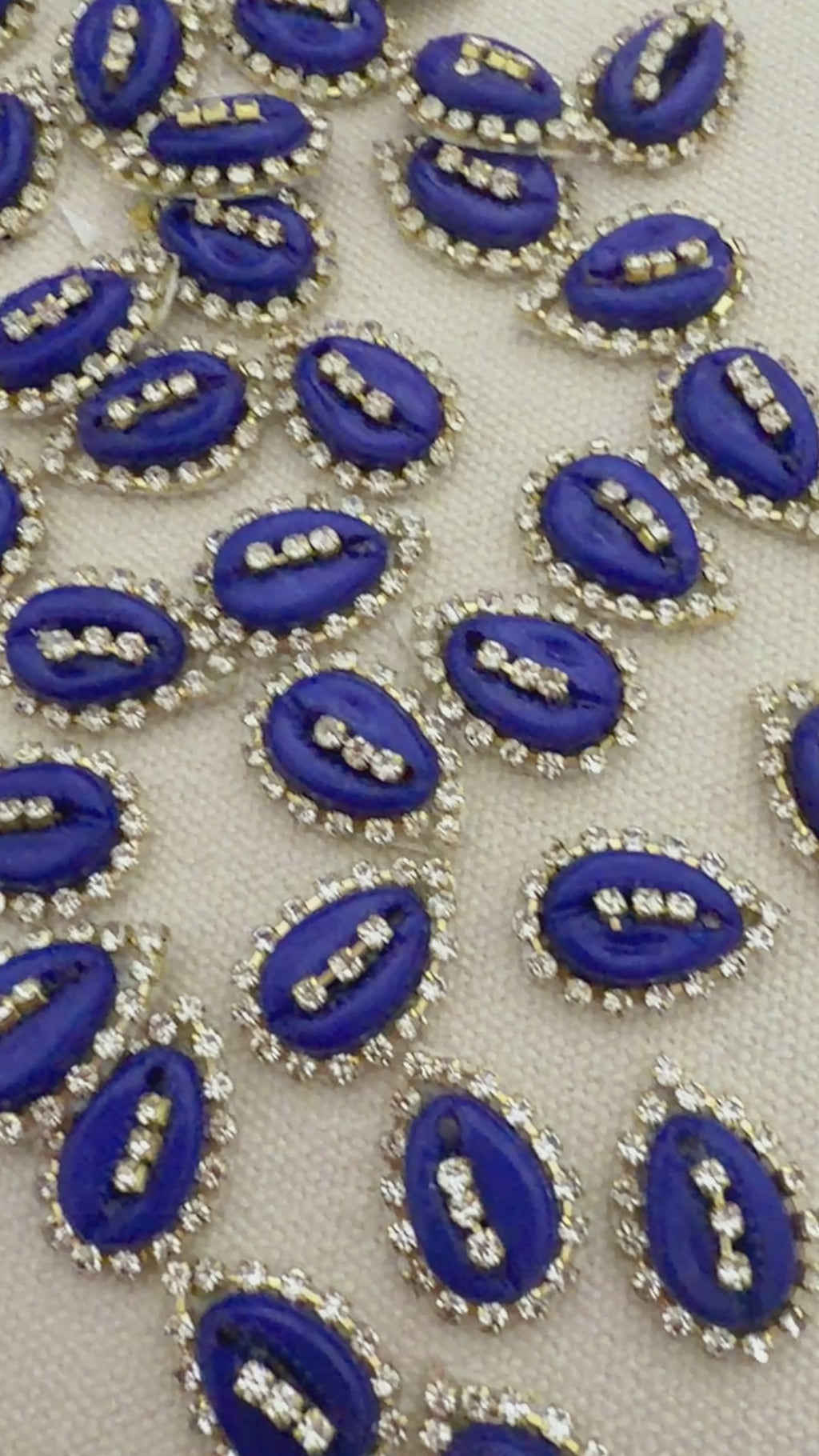 Pattern of blue and silver decorative elements on a beige background