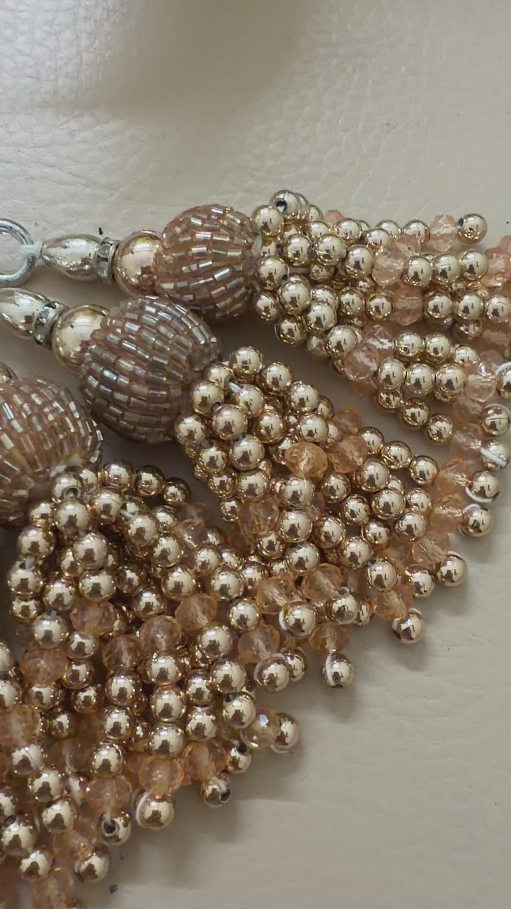 Beaded necklace with tassels on a light background
