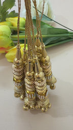 Gold necklace with beads and pendants on a white background