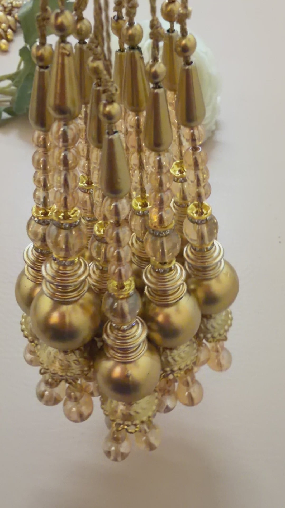 Set of gold hairpins with beads and pearls on a beige background