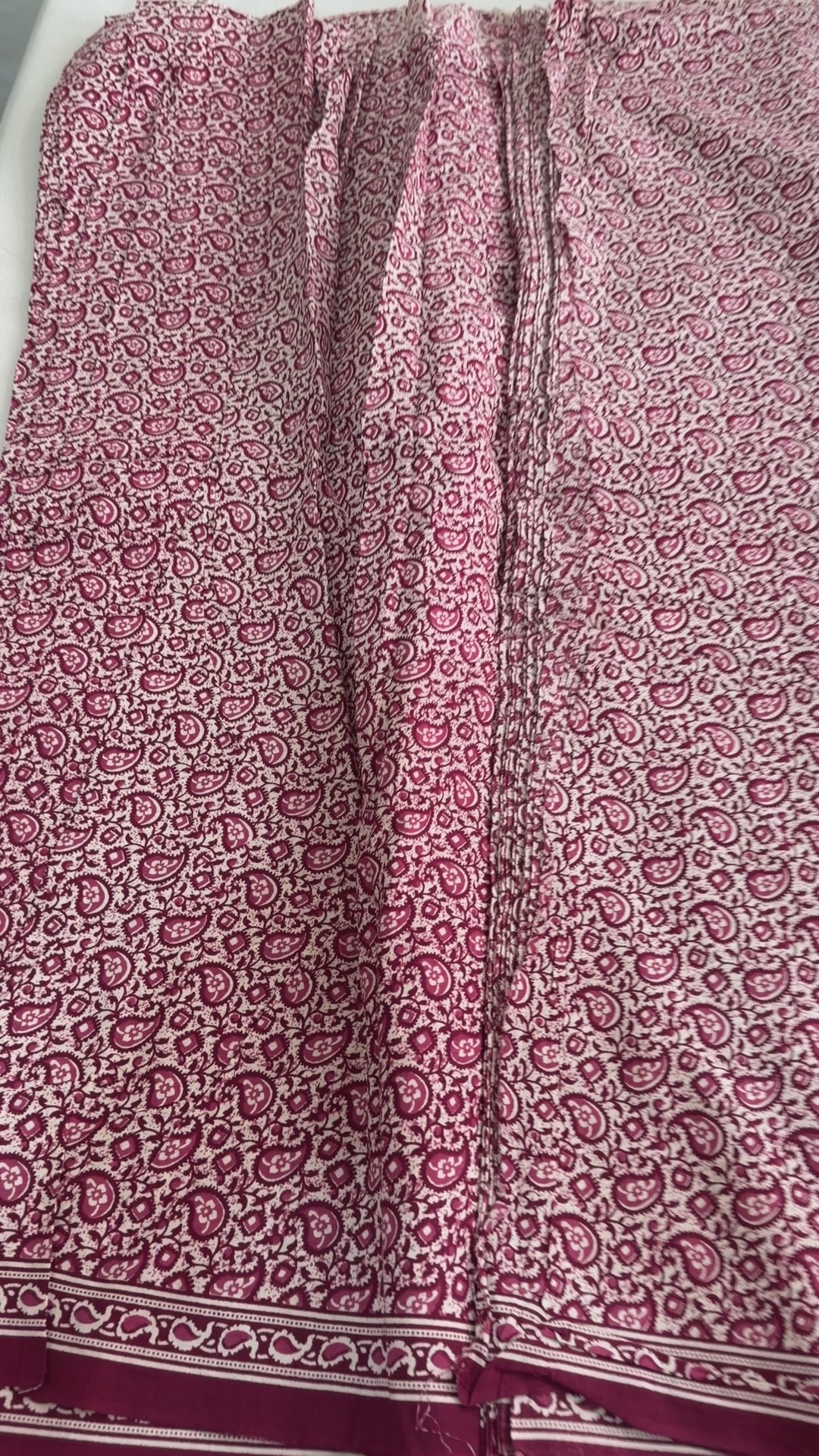 Patterned skirt with a red and white design on a white background