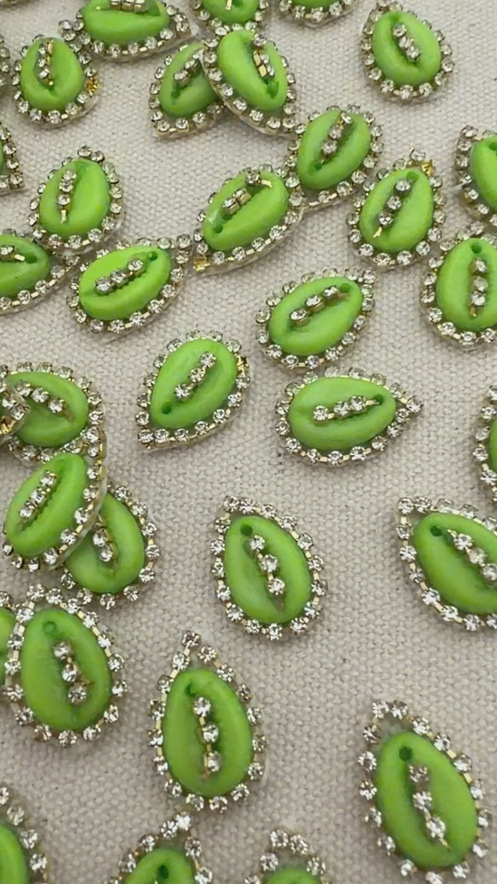 Pattern of green decorative elements with silver accents on a light gray background