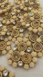 Decorative embellishments with gold and beige patterns on a textured surface