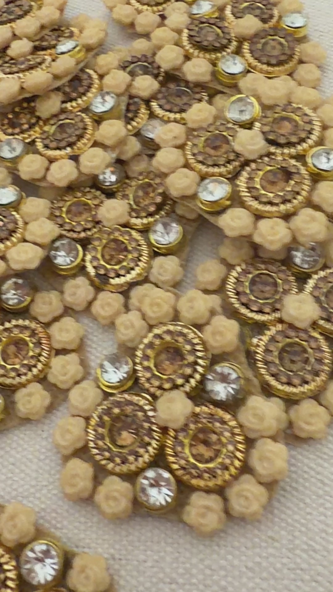 Decorative embellishments with gold and beige patterns on a textured surface