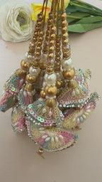 Decorative hair accessories with colorful beads and gold elements on a beige background