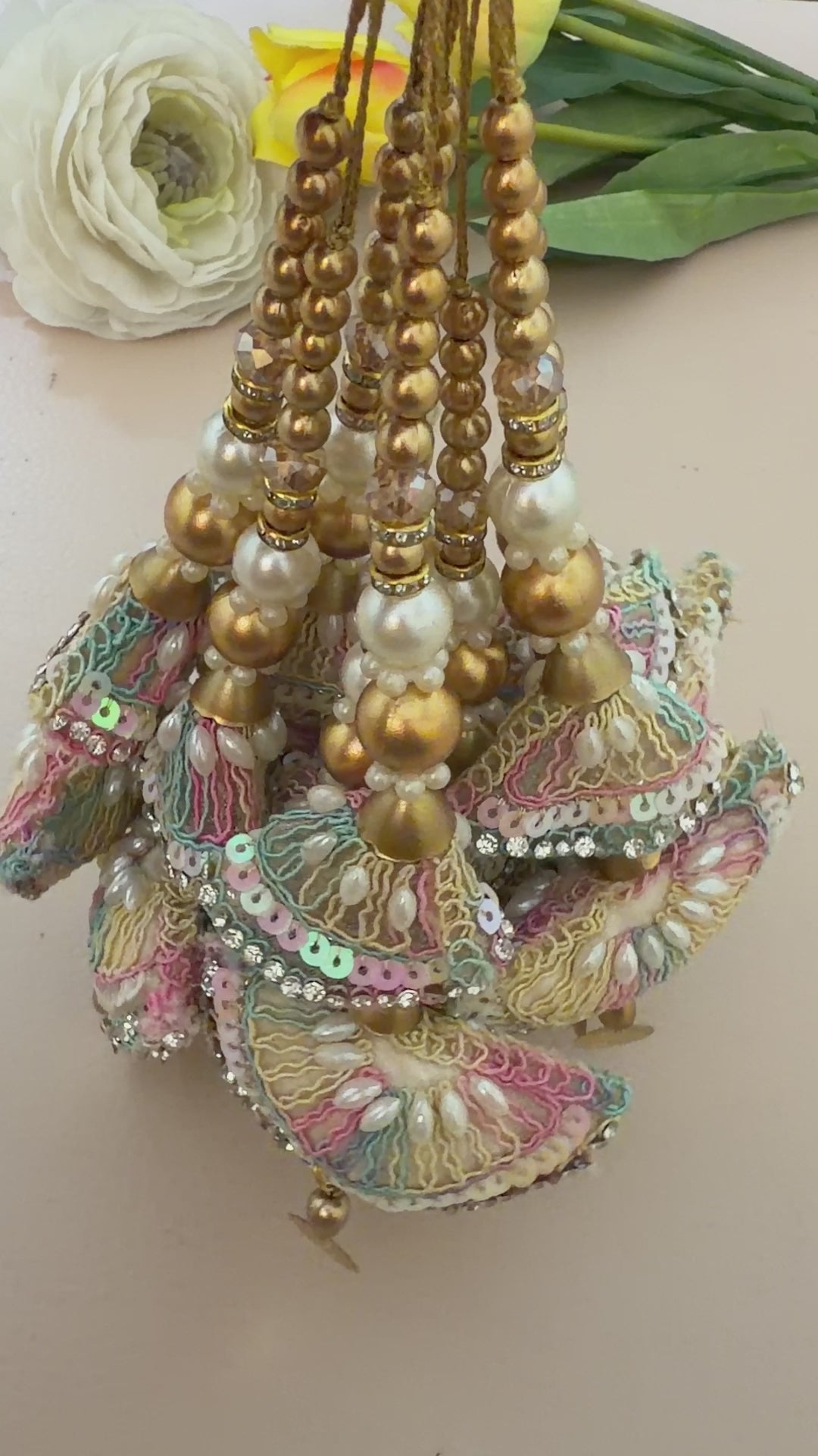 Decorative hair accessories with colorful beads and gold elements on a beige background