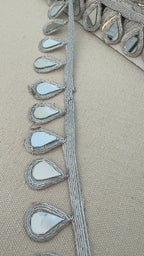 Decorative planter with reflective teardrop designs on a neutral background